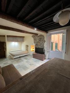 a large room with a bed and a stone wall at Iris 3: Un Fiore a Camogli in Camogli
