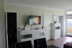 a living room with a flat screen tv on a wall at Apartment KY481 im Panoramic Hohegeiß in Hohegeiß