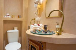 a bathroom with a sink and a toilet at Flowers riad in Marrakech