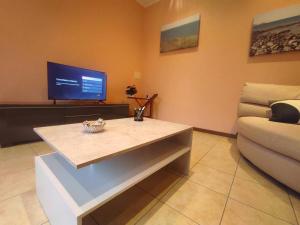 a living room with a table and a couch at Casa Zia Luisa in Lecco