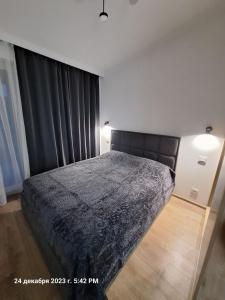 A bed or beds in a room at TbiliHome