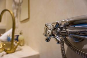 a metal faucet of a sink in a bathroom at Flowers riad in Marrakesh