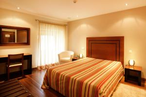 Uma cama ou camas num quarto em Casa Dos Poos