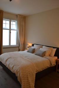 1 cama grande en un dormitorio con ventana en Exclusive ground floor place near market square en Brujas