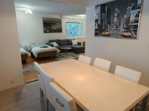 a dining room and living room with a table and chairs at Suuri huoneisto isommalle ryhmälle / Large apartment for bigger group in Tampere