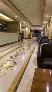 a lobby with leather chairs and a bowling alley at SANSA HOTEL in Jeddah