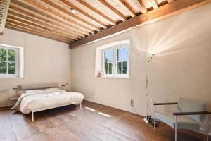 a bedroom with a bed and two windows at Casinotuerm in Ehnen