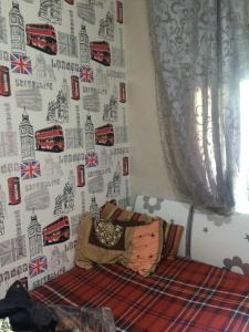 a bedroom with a wall with a wallpaper with a bus at Gessy in Salé