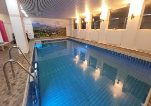 a large swimming pool with lights in a building at Alpenstadel_B18 in Oberstdorf