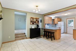 a kitchen with a counter and chairs in a room at The Rest on the River in Cedar Falls