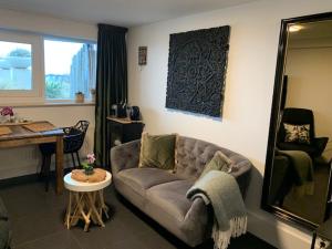 een woonkamer met een bank en een tafel bij B&B Zeespiegel in Zandvoort