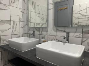 a bathroom with a white sink and a mirror at SLM - Le clos Gaïac - A in Saint-Laurent du Maroni +38 photos