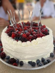 a cake with berries on top of it on a table at Villa Etelvina in Torotoro