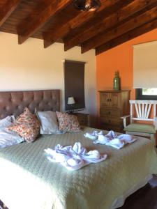 a bedroom with a bed with towels on it at MiraSierras -casas vacacionales- in Villa General Belgrano +32 photos