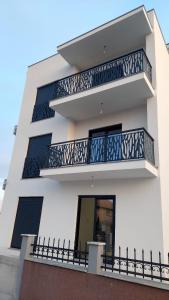 a white building with balconies on it at Vila Palace with kitchen in Donji Štoj