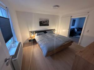 a bedroom with a bed and a living room at Ferienwohnung am Berg in Wolfshagen