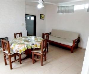 a room with a table and chairs and a bed at Lo de Liliana 1 in Tanti