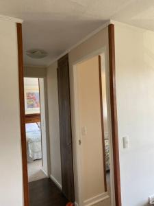 a room with a hallway with two doors and a bedroom at Acogedor dpto en puerto varas in Puerto Varas