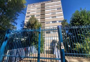 a gate in front of a tall building at L'Open d'Australie in Chalon-sur-Saône
