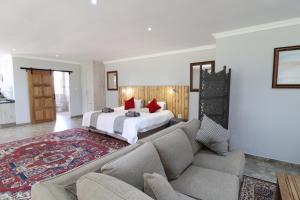 ein Schlafzimmer mit einem Bett und einem Sofa in einem Zimmer in der Unterkunft 7 At Brainline in Pretoria