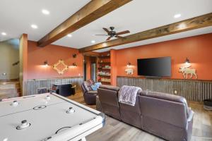 a living room with a tv and a pool table at Barkada Cabin Blue Ridge, GA in Blue Ridge