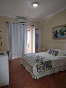a bedroom with a large bed and a window at Pousada do Bosque in Rio das Ostras +32 photos