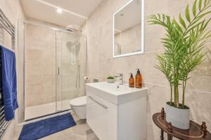 a bathroom with a sink and a toilet and a shower at 9 Admiralty House Stunning Luxury Apartment with free parking in Plymouth +28 photos