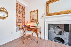 a home office with a desk and a fireplace at 9 Admiralty House Stunning Luxury Apartment with free parking in Plymouth