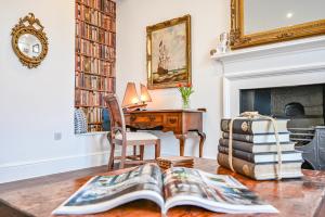 a living room with a desk and a book on a table at 9 Admiralty House Stunning Luxury Apartment with free parking in Plymouth