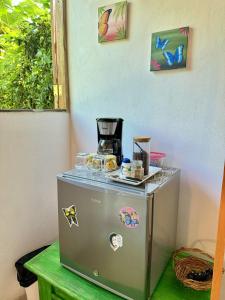 a small refrigerator with stickers on it on a table at Casa Mariposa in Puerto Viejo