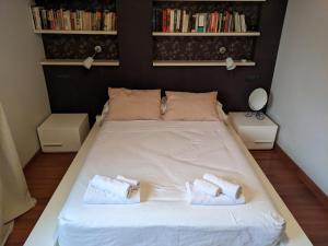 a bedroom with a bed with two towels on it at Casa del Doctor in Seville