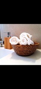 a basket of towels sitting on a bathroom counter at בין הר ליער - צימרים באודם in Odem