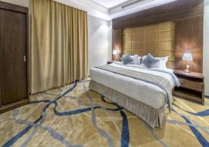 a bedroom with a large bed and a large carpet at SANSA HOTEL in Jeddah