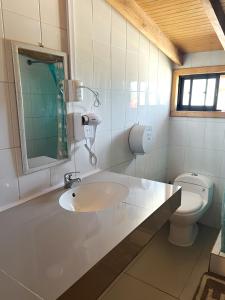 a bathroom with a sink and a toilet at Hostal Central Panguipulli in Panguipulli