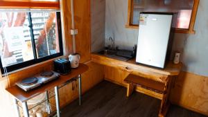 a small kitchen with a counter and a window at Hostal Central Panguipulli in Panguipulli