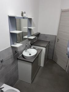 a bathroom with a sink and a mirror at Nina's house 2, a 300 metri dal mare in Santa Caterina Dello Ionio Marina