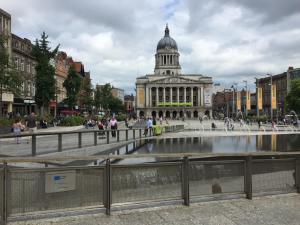 a building with a fountain in the middle of a city at Quieter Studios Centre of Nottingham in Nottingham