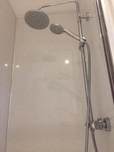 a shower with a shower head in a bathroom at Quieter Studios Centre of Nottingham in Nottingham