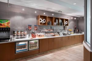 a restaurant kitchen with a counter with food at SpringHill Suites by Marriott Syracuse Carrier Circle in East Syracuse