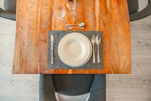 a person with a plate and glasses on a table at Ferienwohnung an der Elbe - XR43 in Seevetal