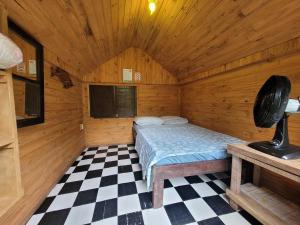 a bedroom with a bed in a wooden room at Pousada e Camping do Clodo in Ilha do Mel