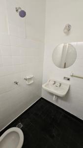 a bathroom with a sink and a mirror and a toilet at Hotel Rid in Mar del Plata