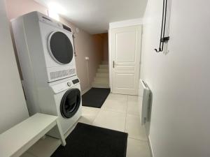a laundry room with a washer and dryer at Changalan II in Vars