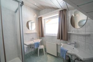 a bathroom with a sink and a mirror and a shower at Haus Kössler in Radstadt
