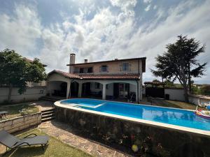 a house with a swimming pool in front of a house at Family House FreeДом in Sinemorets