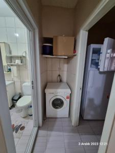 a small bathroom with a toilet and a washing machine at Kiralık Daire in Istanbul