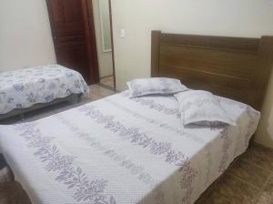 1 dormitorio con 2 almohadas en Casa Temporada em Alto Caparaó, en Caparaó Velho