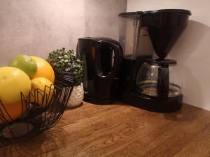a coffee maker and a basket of fruit on a counter at Modern house on the countryside in lovely Bohuslän in Uddevalla