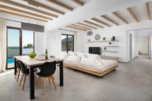a living room with a couch and a table at Terra Pietra Luxury Villas & Suites in Lardos +96 photos