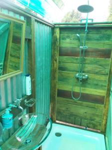 a bathroom with a shower and a glass sink at Wilderness Glamping Tents in Wilderness